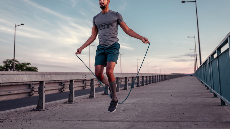 man jumping rope outside