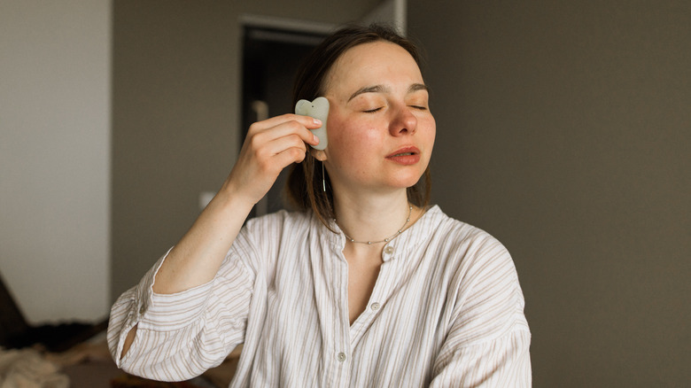 Woman doing gua sha massage