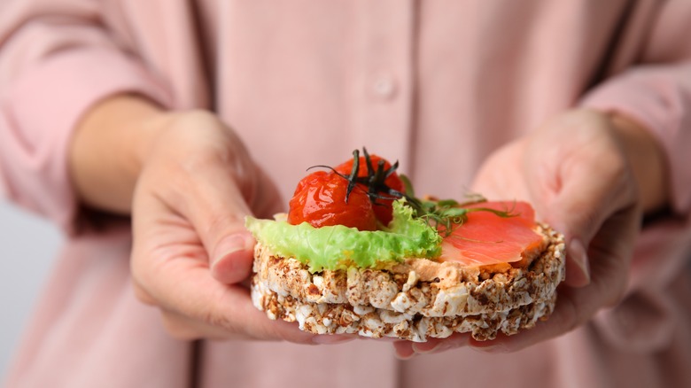 Sandwich with whole rice cakes, salmon, and veggies