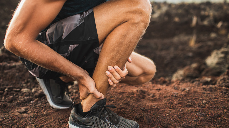 Hiker holding their ankle