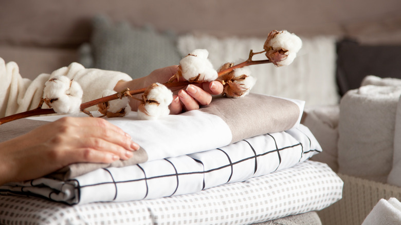 Woman's hands on top of hand towels