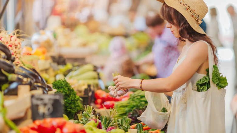 woman shopping for vegetables at farmers market