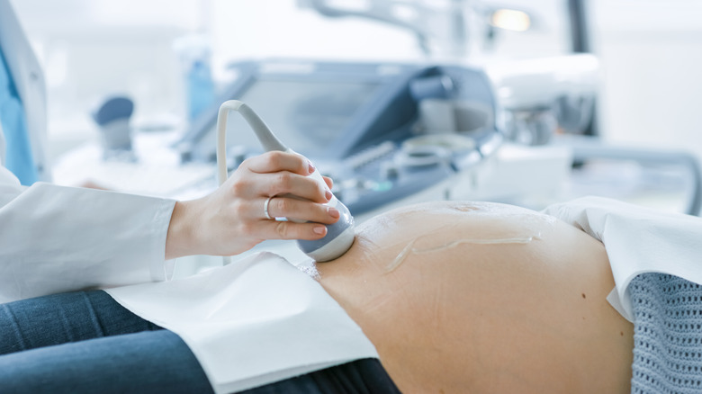 Closeup of pregnant person having ultrasound
