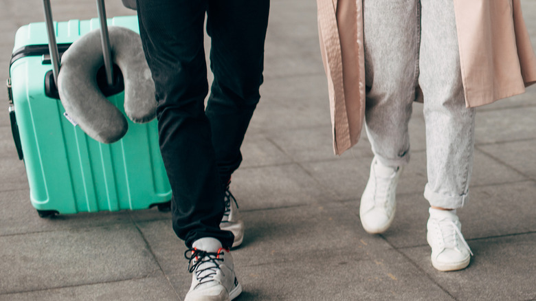 Smiling couple on a trip walking