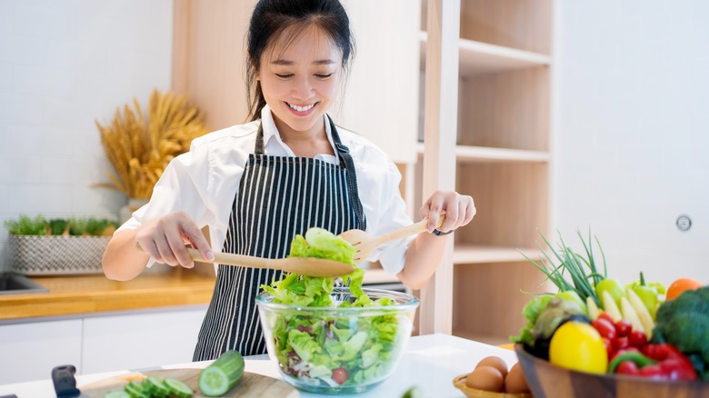 Woman making a green salad