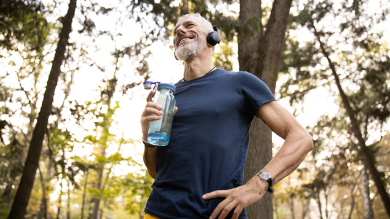 Man holding water bottle after exercise