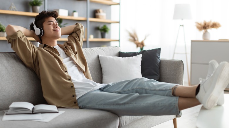 Asian man relaxing on couch
