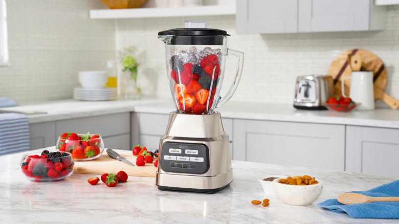 blender with bright berries and almonds