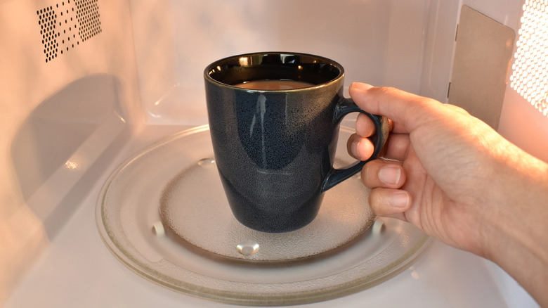 Mug with tea in microwave