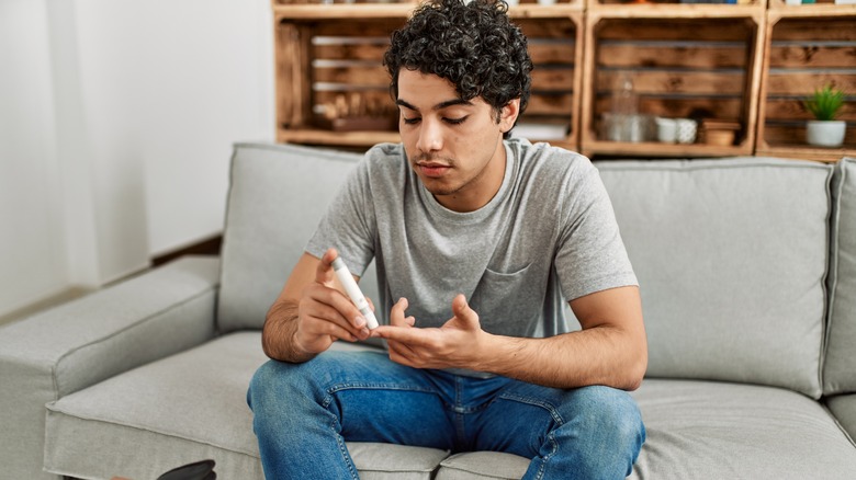 man with diababetes checking blood sugar