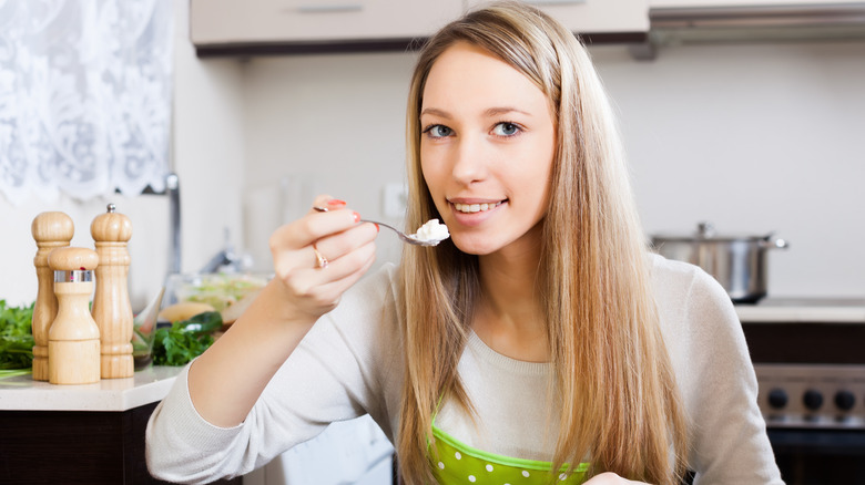Woman eating cottage cheese