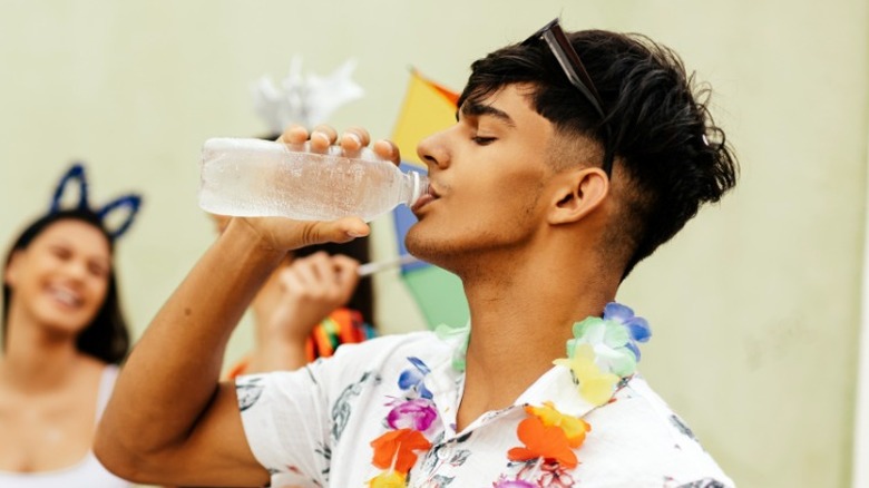 young man drinking water