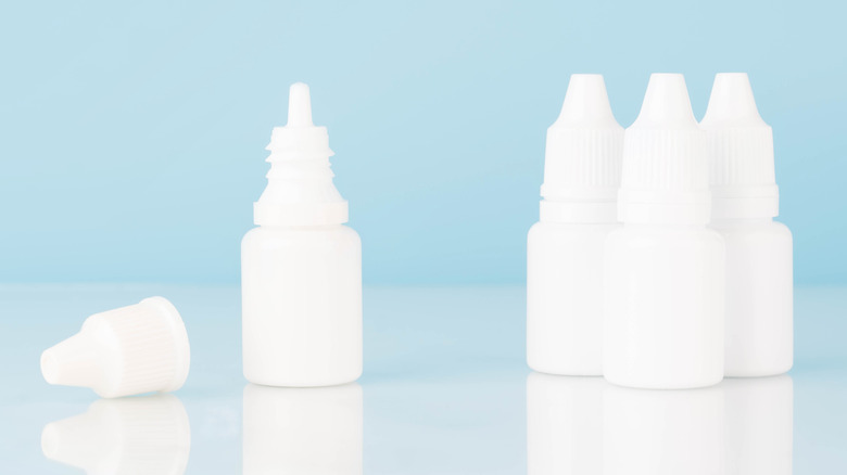 Eye drop bottles on blue background