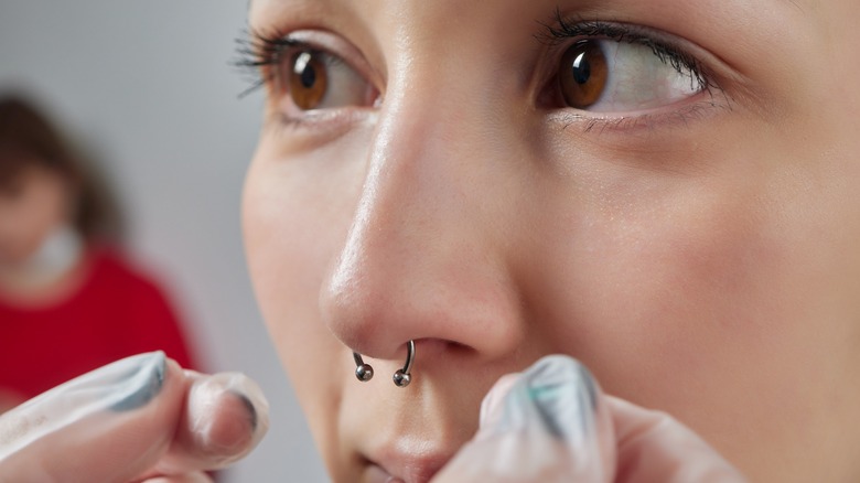 woman getting her nose pierced