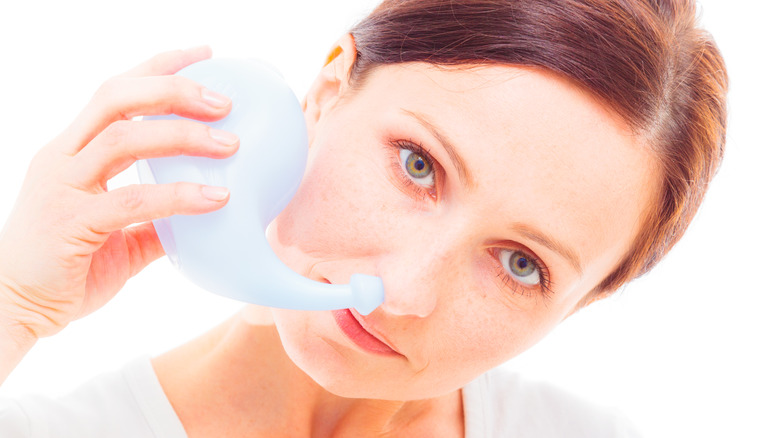 adult woman using a neti pot