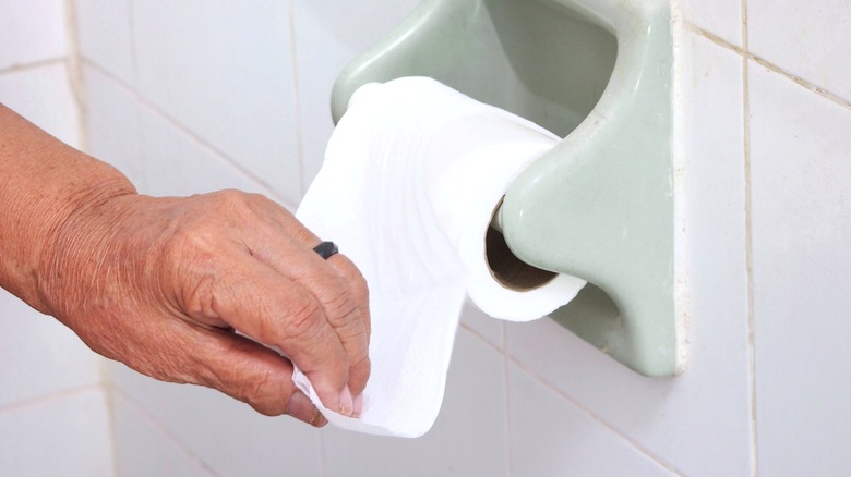 woman pulling tissue