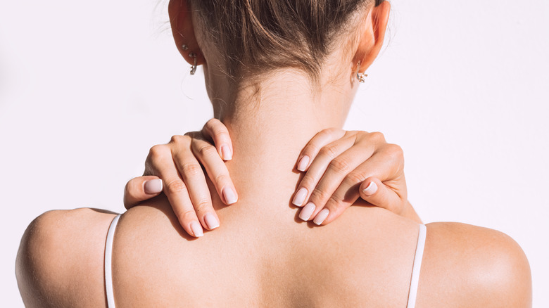 woman massaging her shoulders