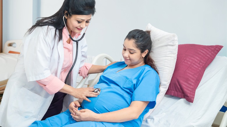 doctor giving pregnant woman a checkup