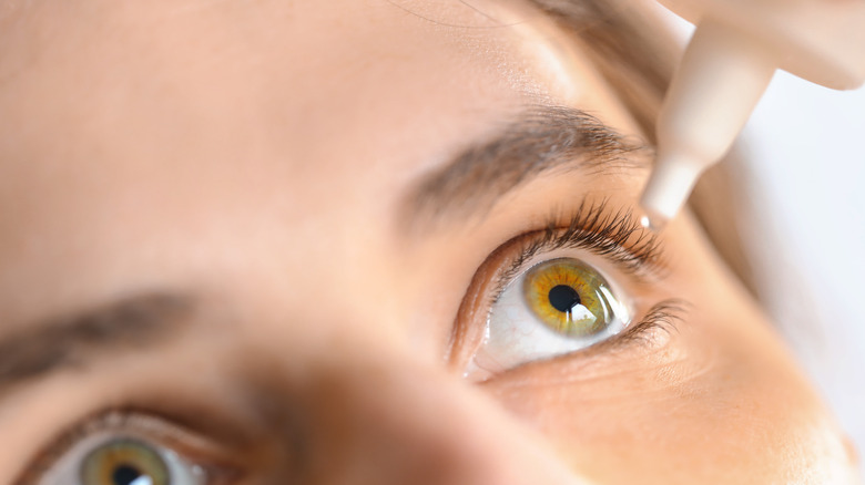 Woman using eye drops