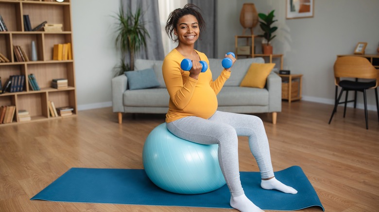 Pregnant woman working out on an exercise ball