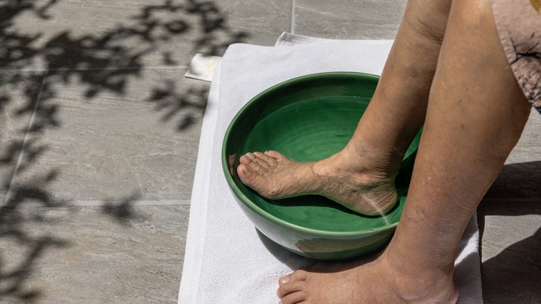 Person soaking their feet in warm water 