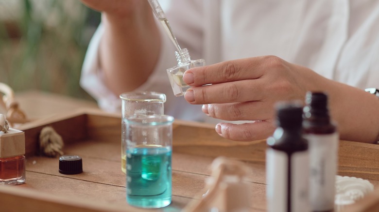 woman creating perfume in a workshop