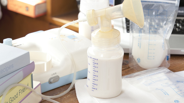 Breast pump with milk sits on a table