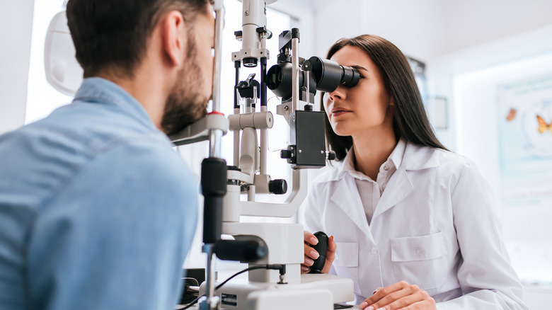 An eye doctor looks at a patient's eyes