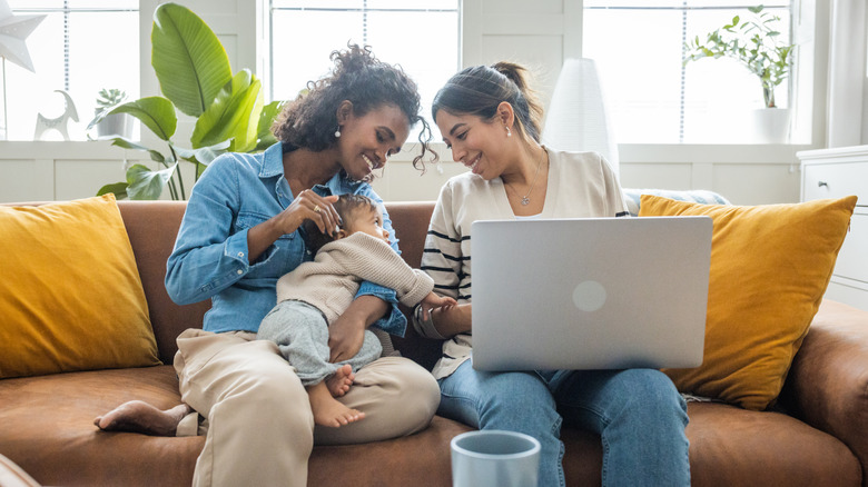 A couple with a baby on computer