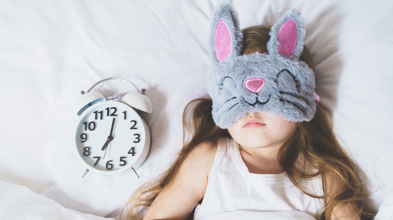 young girl with a fuzzy bunny sleep mask