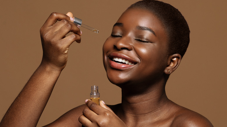 black woman using essential oils