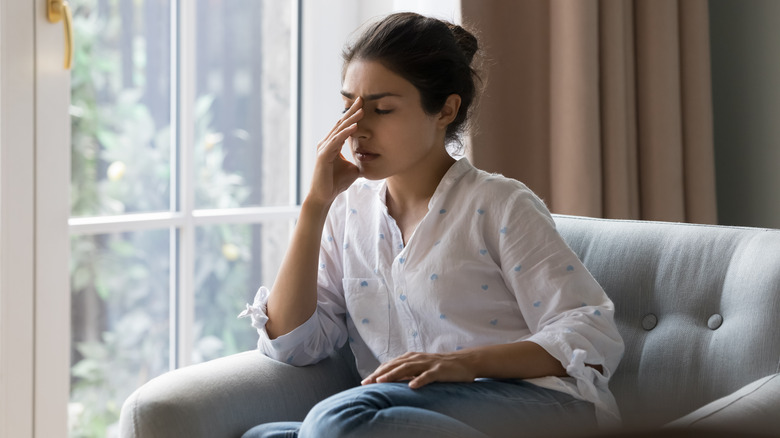 Fatigued woman on couch