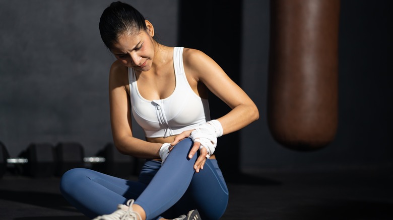 Woman touching sore knee