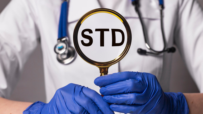 Magnifying glass with STD signage