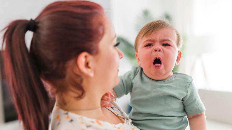 Mother with sick baby with a cough