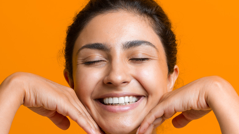 young woman doing face yoga