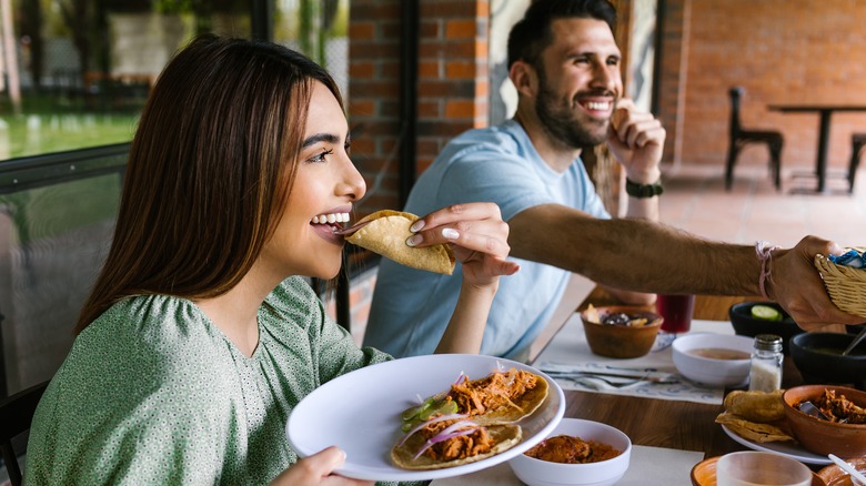 Couple eating tacos 