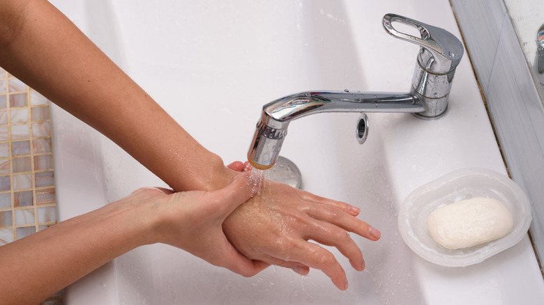 A person runs their hand under water