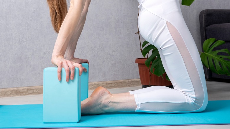 camel pose with hands on block