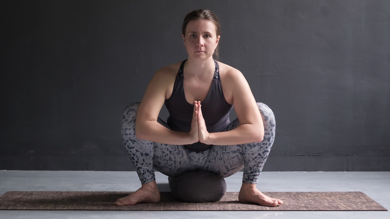 Woman doing garland pose sitting