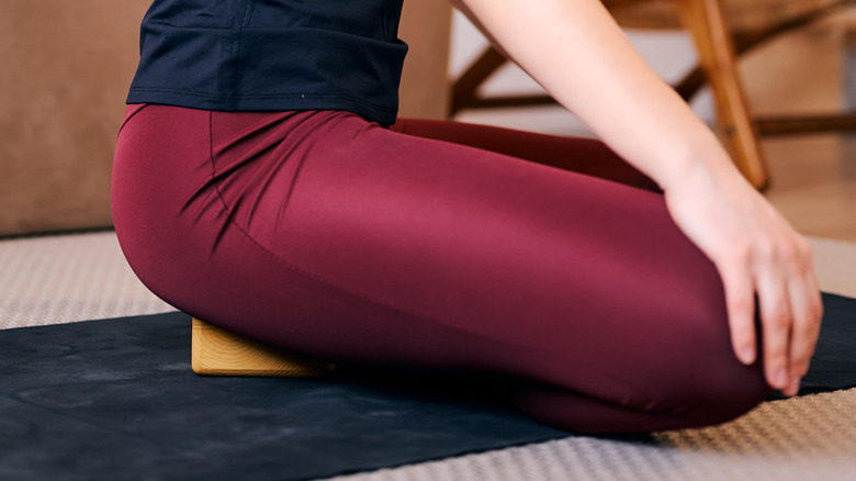  person sitting on a yoga block