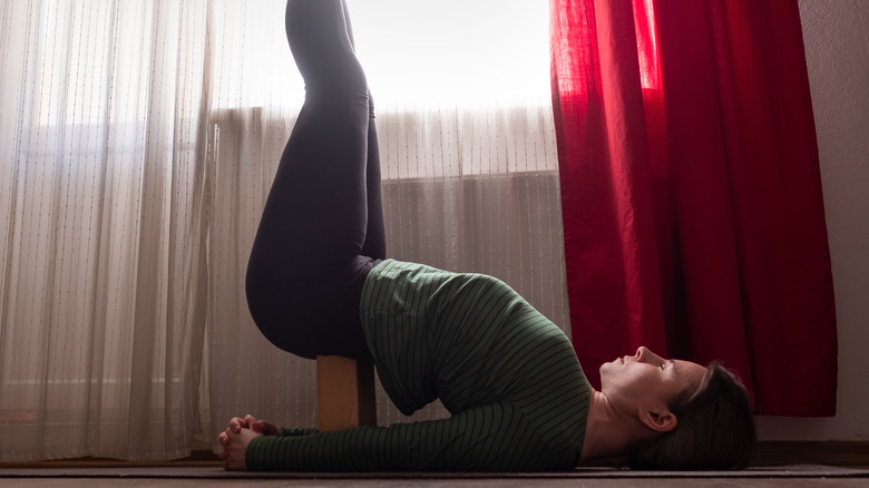 supported shoulder stand pose with block 