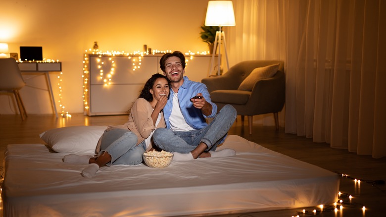 couple on floor mattress with ambient lighting