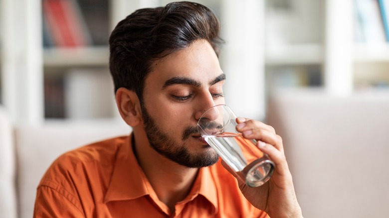 Young man drinking water