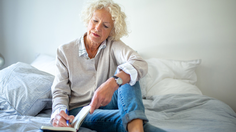 Older woman writing in journal