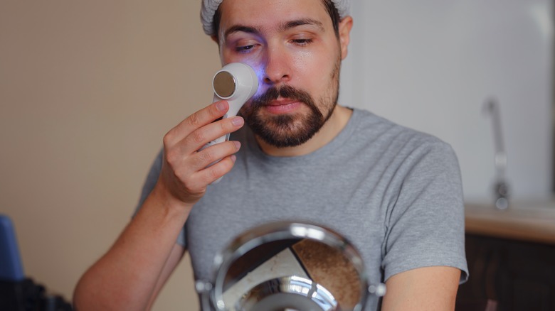 Man using at-home exfoliating device