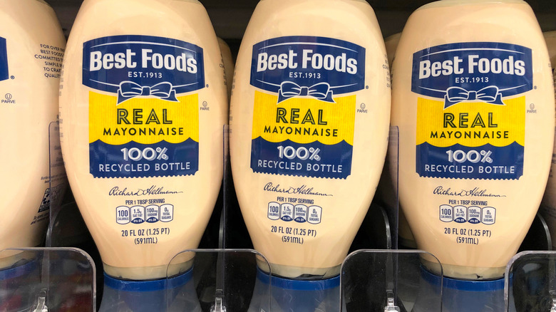 three bottles of mayonnaise on a grocery store shelf