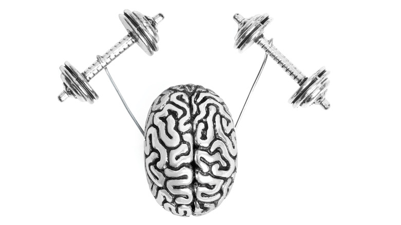 Silver brain holding up two exercise weights