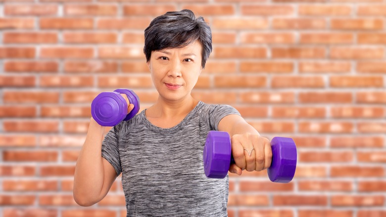 elderly woman using weights
