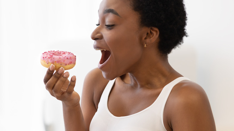 Woman about to eat a donut